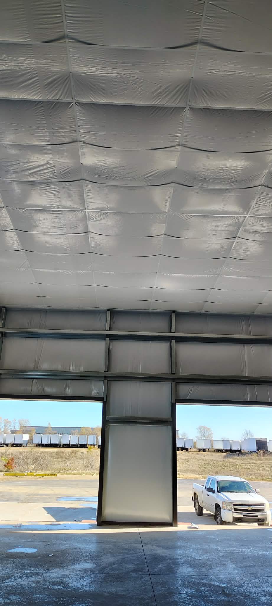 Interior of a large industrial building with insulated ceiling panels.