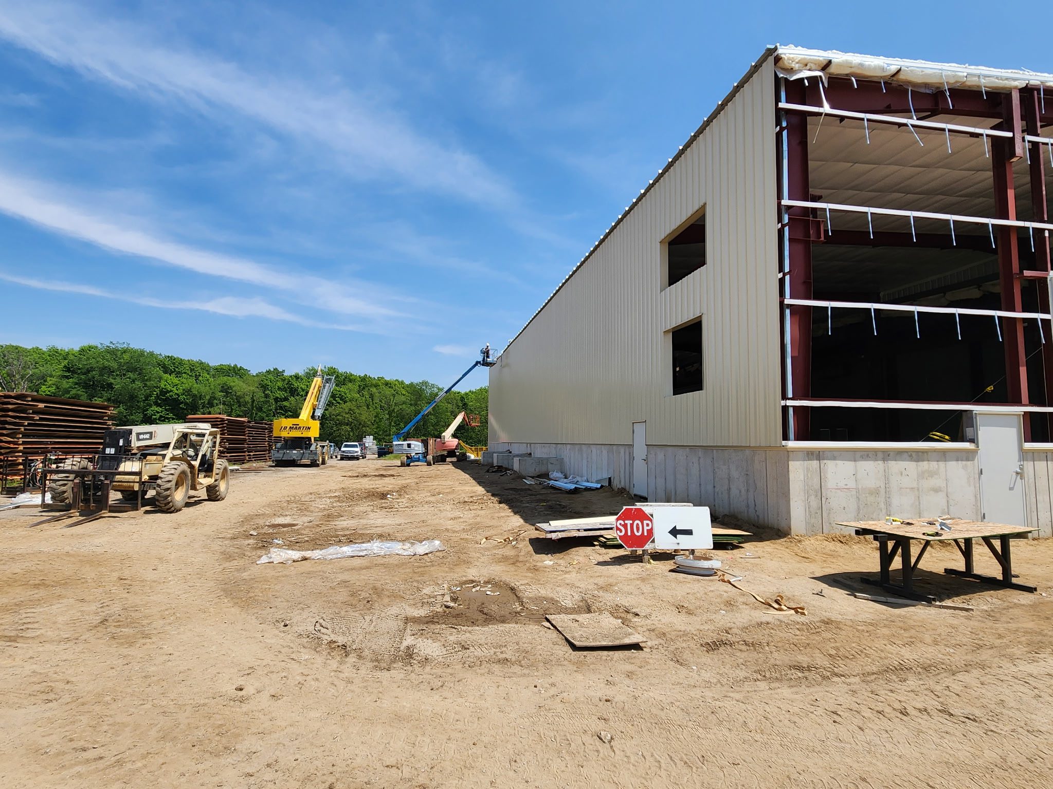 Large industrial building under construction on a clear day.