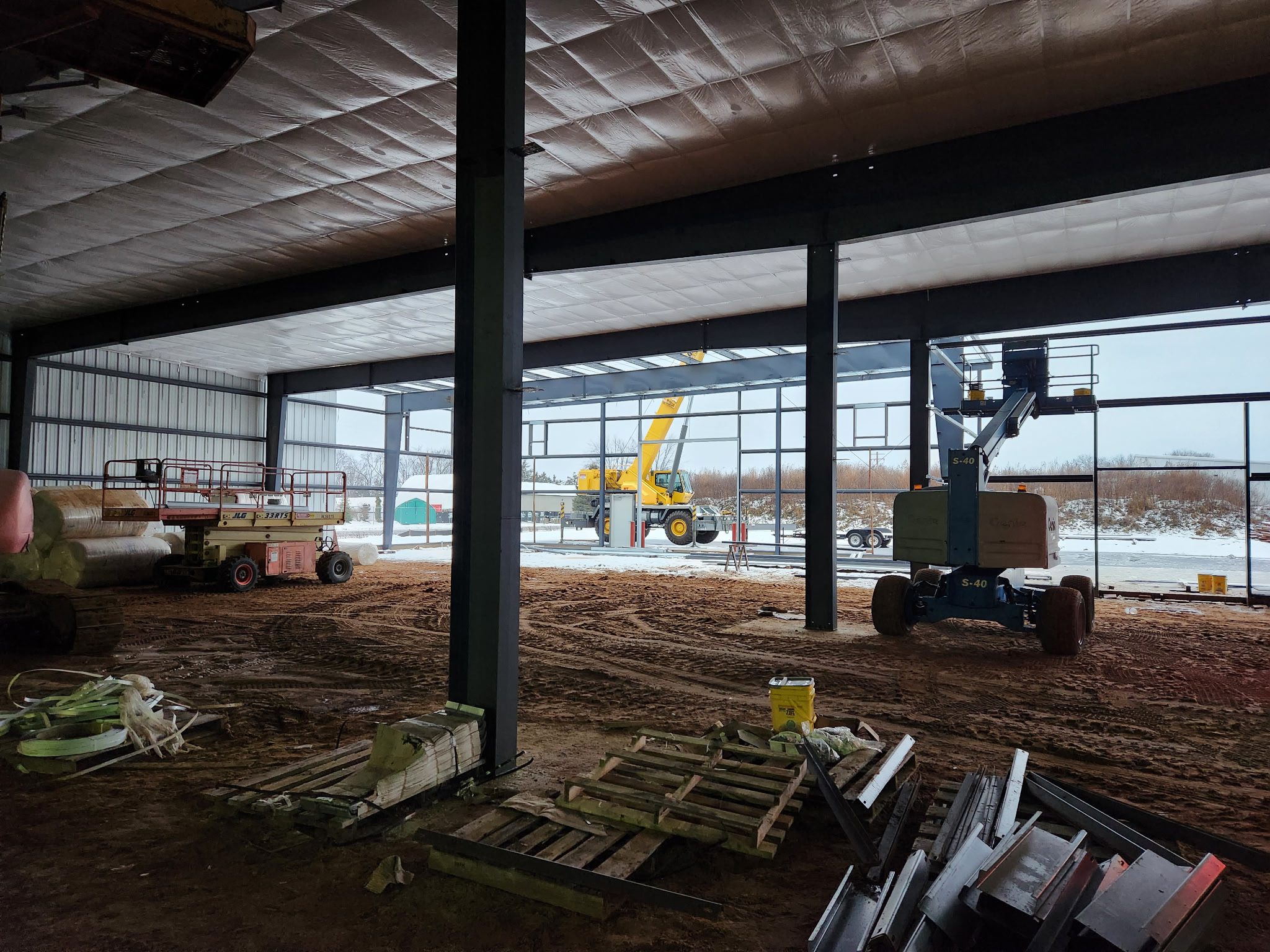 Interior of a building under construction with machinery and materials.