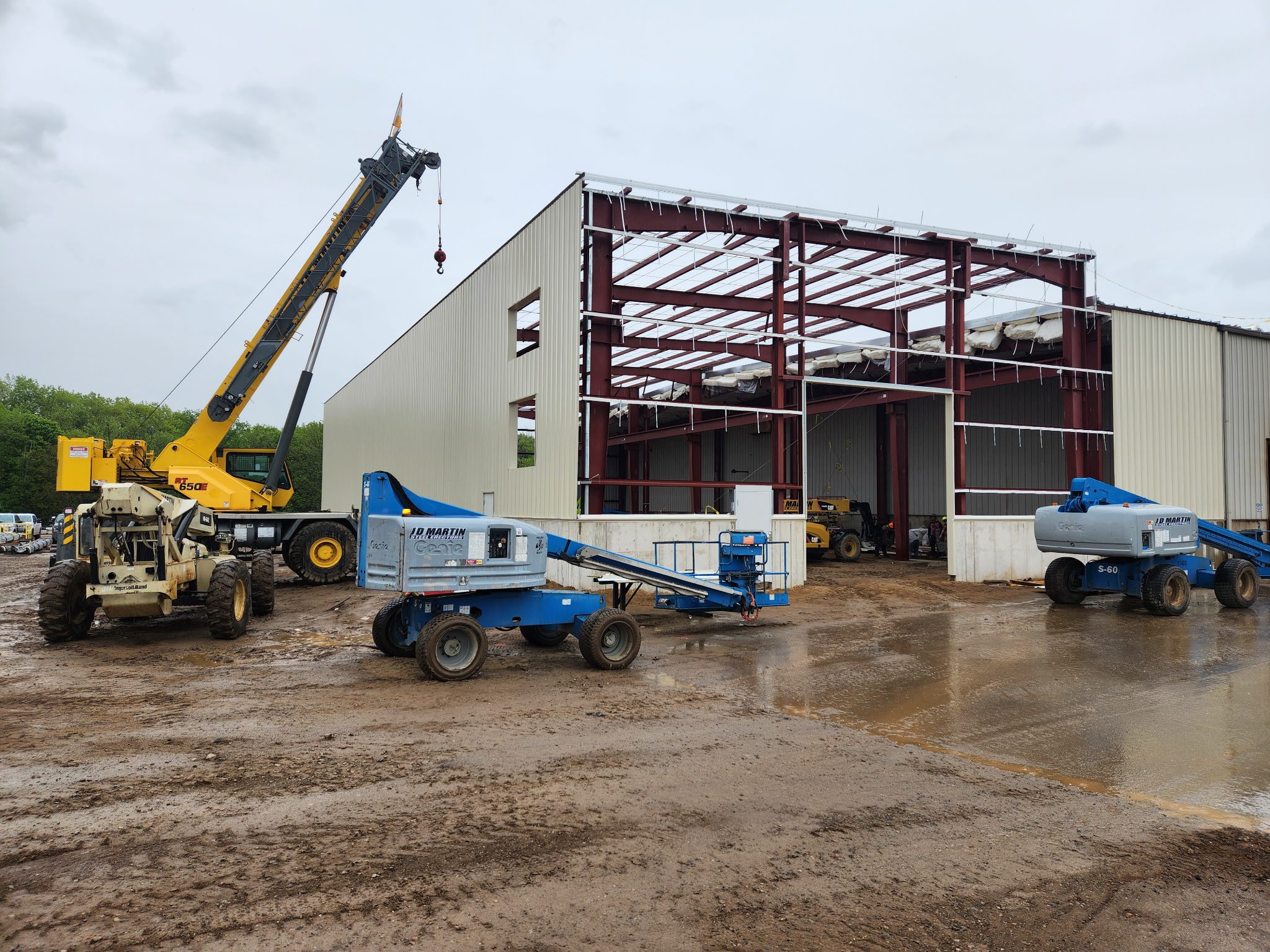 Construction site with cranes and steel framework for a building.